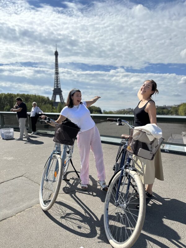 Tourists riding bikes through the streets of Paris, enjoying a scenic tour of the city’s iconic landmarks.